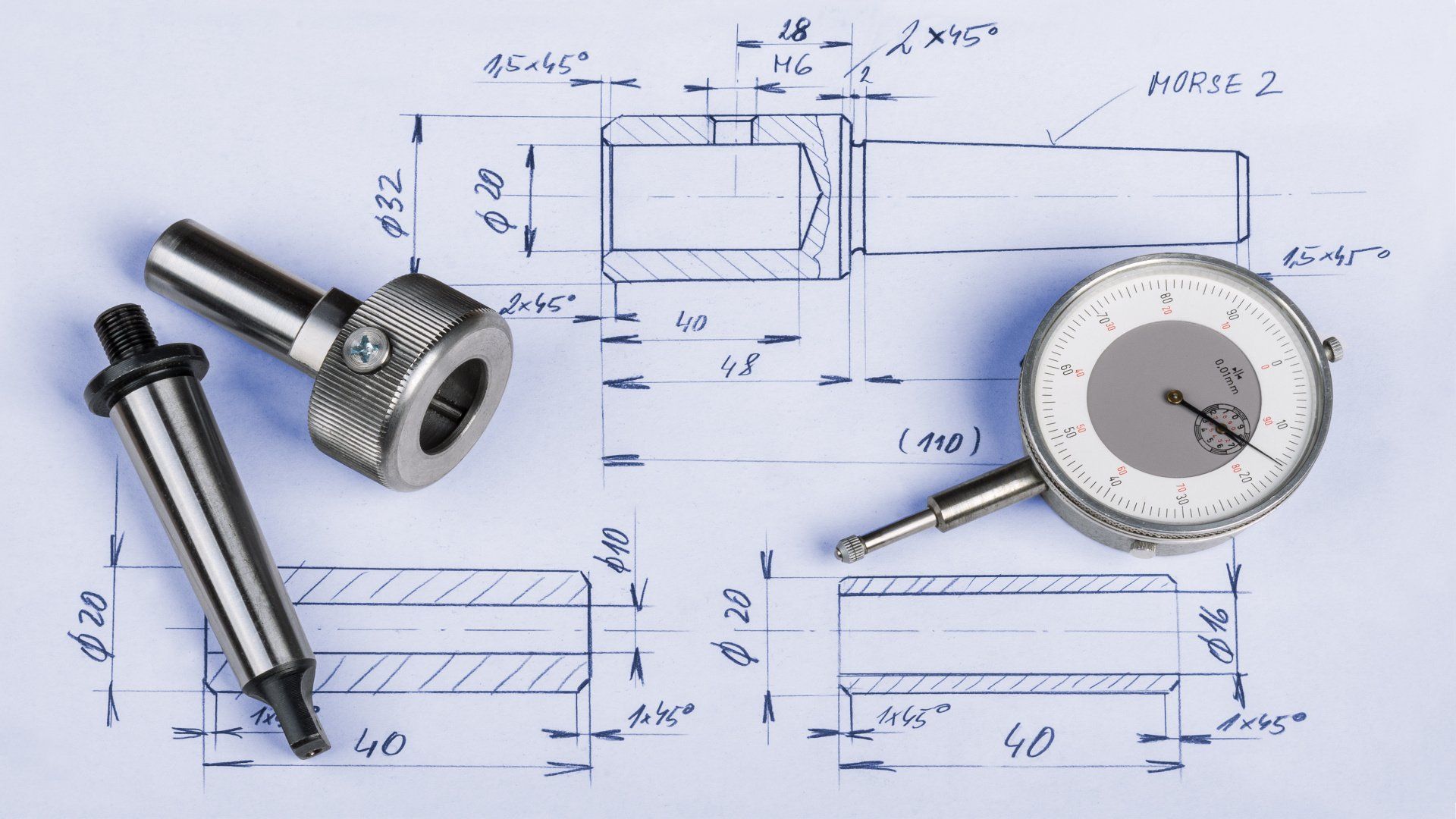A dial gauge is sitting on top of a blueprint