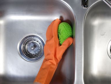 Our bond cleaning team scrubbing a sink on the Gold Coast