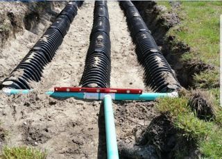 Septic System Flush — Septic Servicing Truck Working in Urban Place in Elmendorf, TX Septic System Flush — Septic Servicing Truck Working in Urban Place in Elmendorf, TX