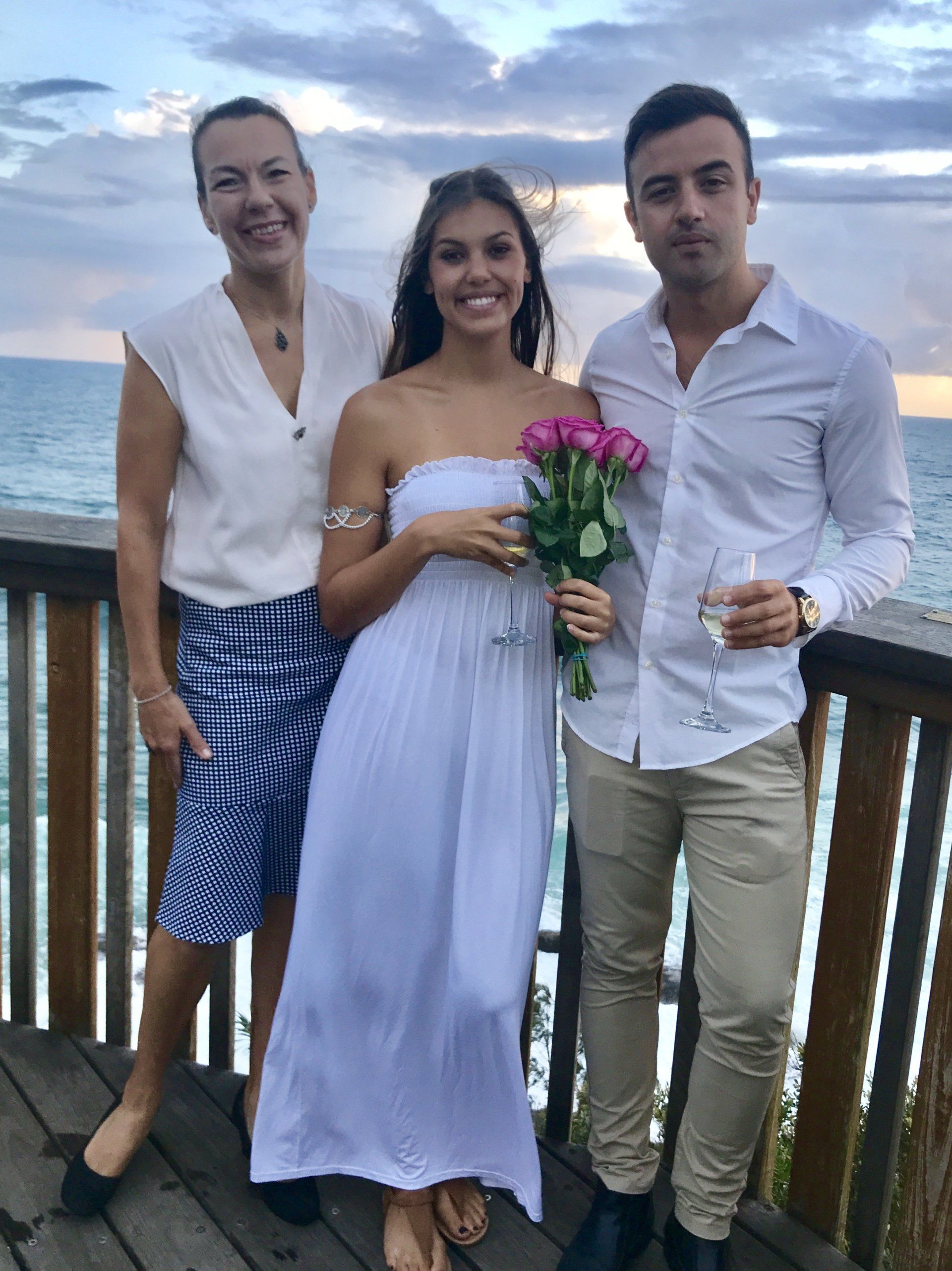 couple with pink roses just eloped on the ocean deck at Dewar Street lookout, Point Arkwright
