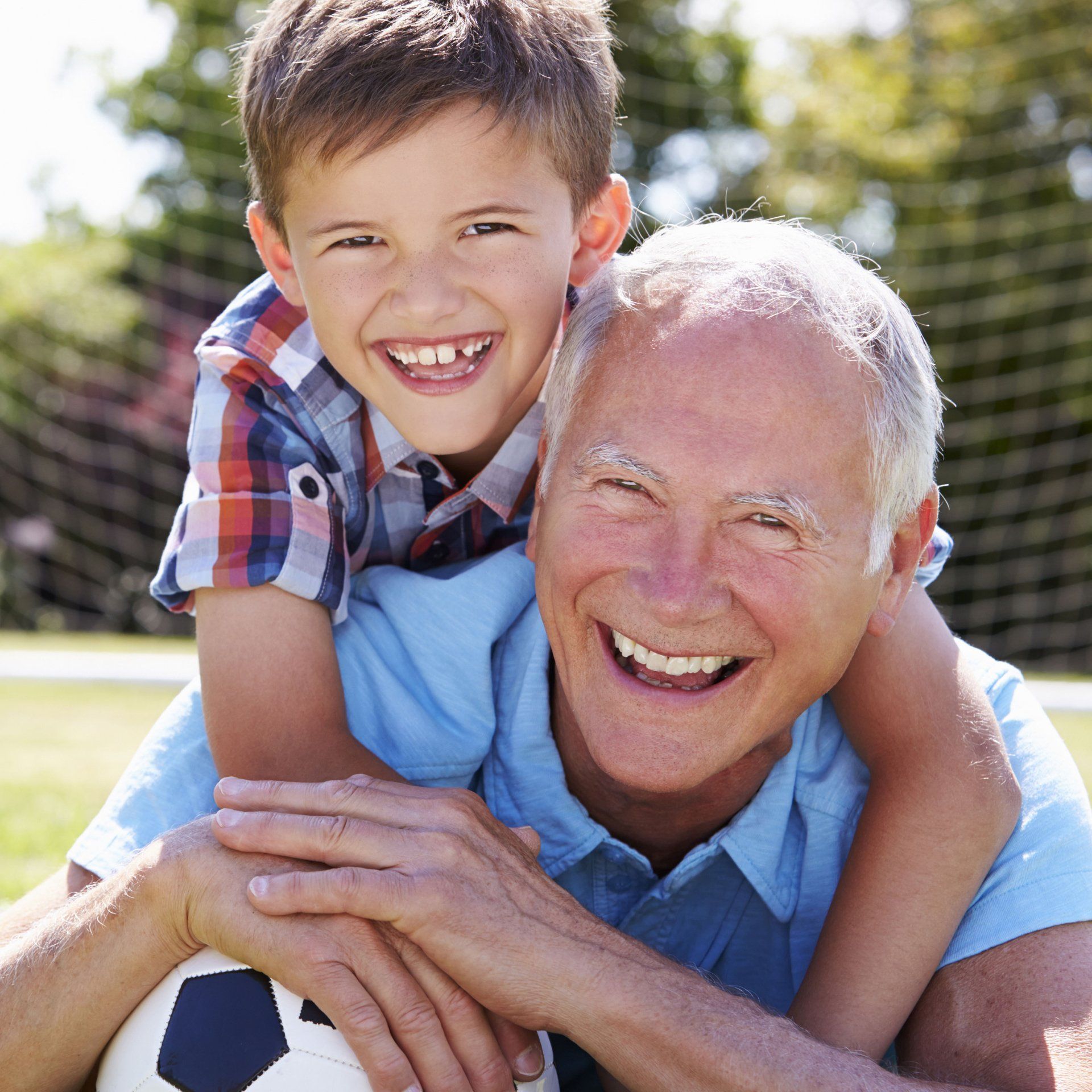 grandfather and grandson smiling