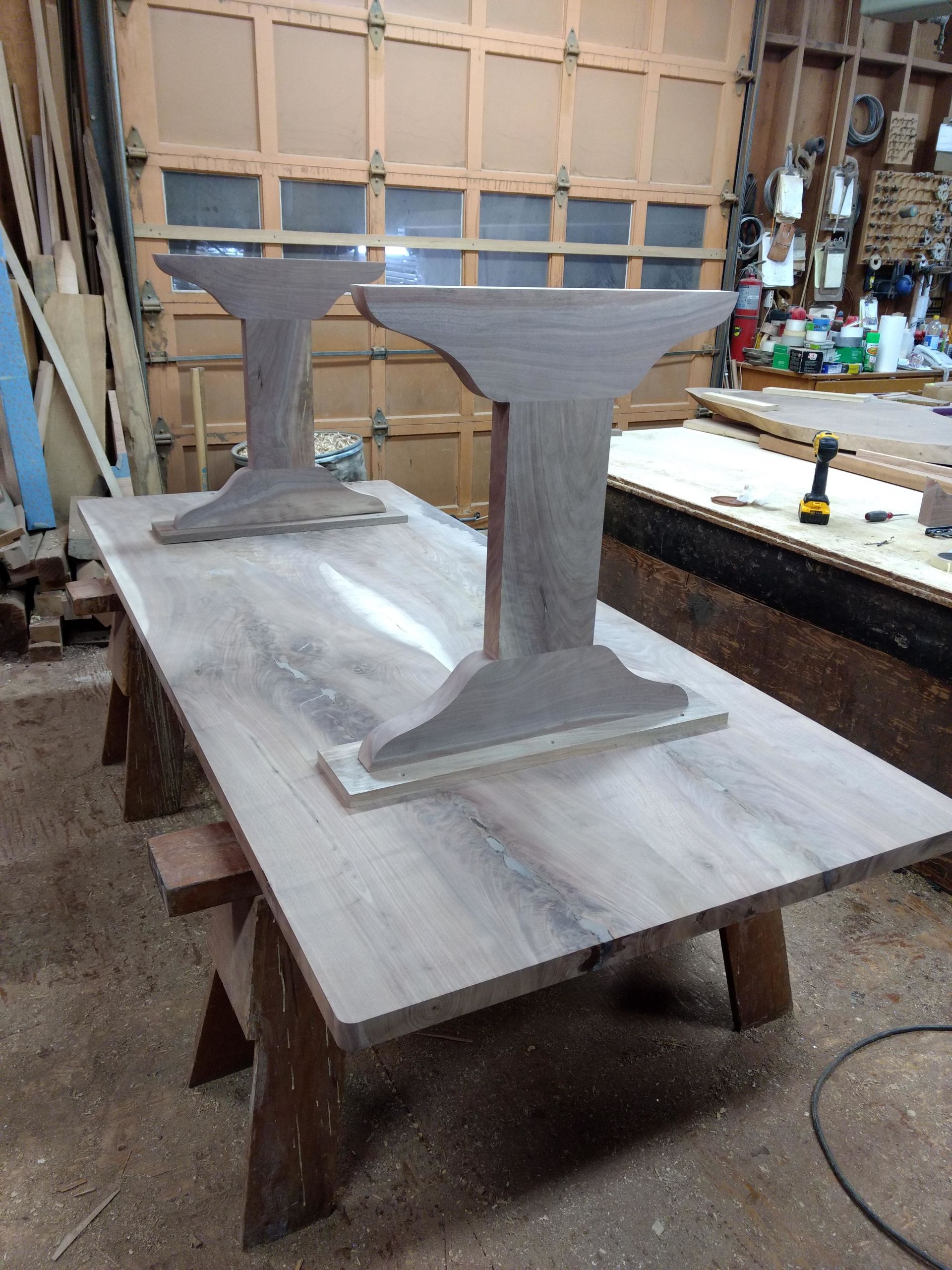 Tabletop with two pedestal bases in a workshop.