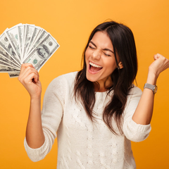 A woman in a white sweater is holding a fan of money