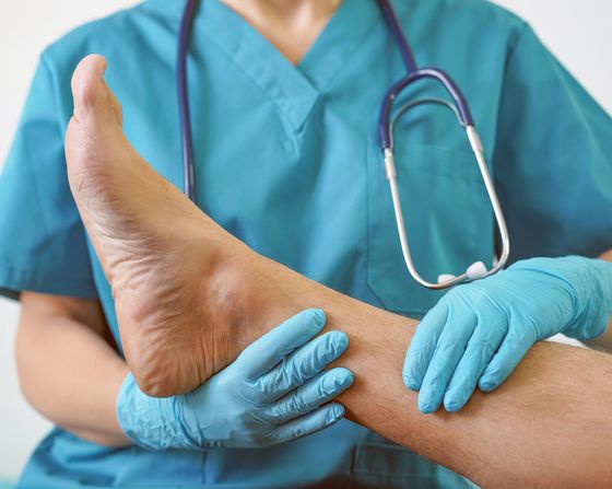 Podiatry Care Center – Doctor Holding Patient’s Leg in West Chester, PA Podiatry Care Center – Doctor Holding Patient’s Leg in West Chester, PA