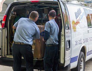 Heating System Installation — Men Picking up a Heater in Nashville, TN