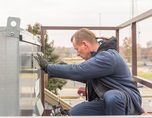 System Repair — Man Checking the HVAC in Nashville, TN System Repair — Man Checking the HVAC in Nashville, TN