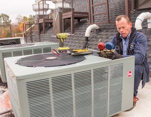 Commercial Plans — A Man Repairing an Air Conditioner in Nashville, TN