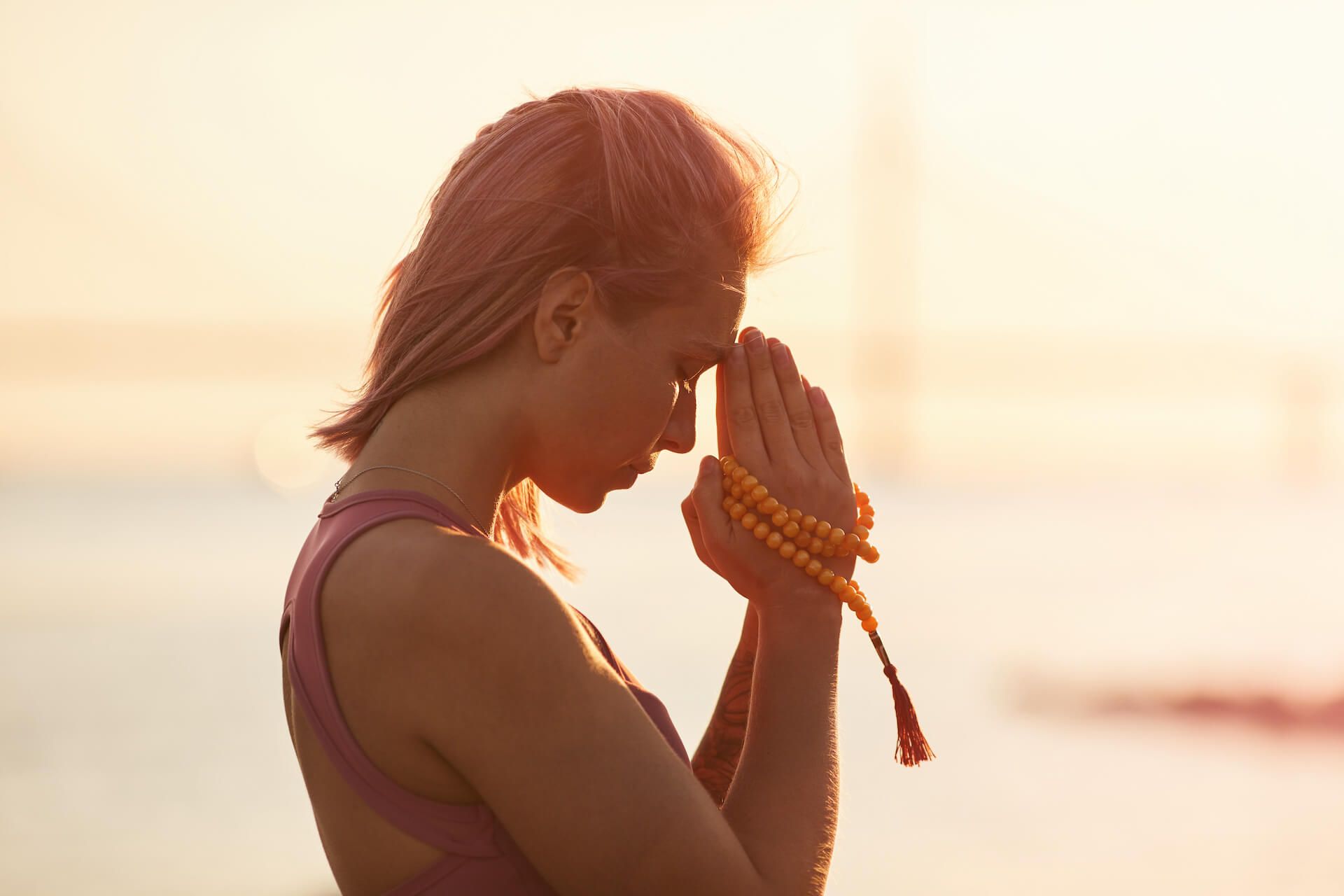 Woman Practicing Yoga During Sunset