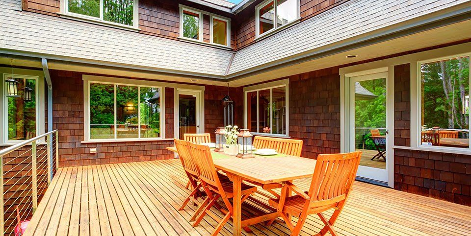 A large decked patio area with new patio furniture