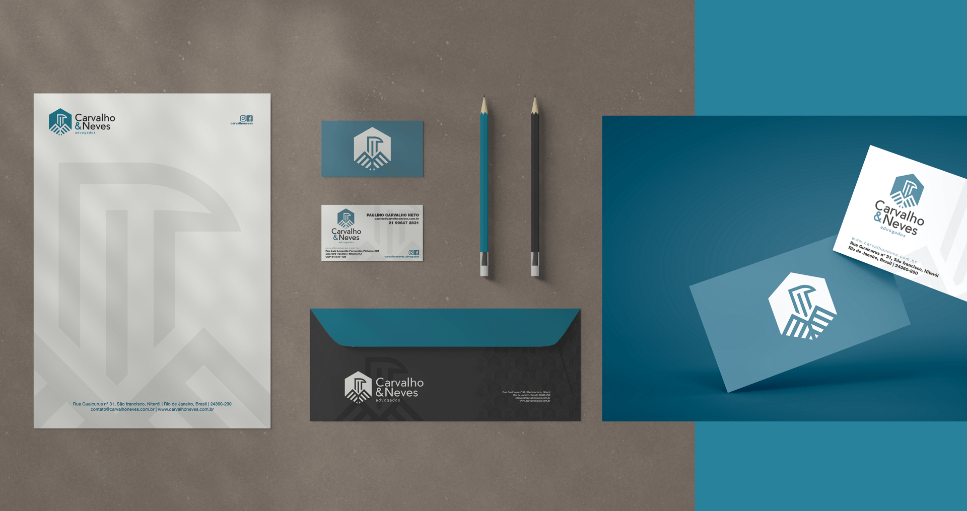 A set of business cards , envelopes , and a pen on a table.