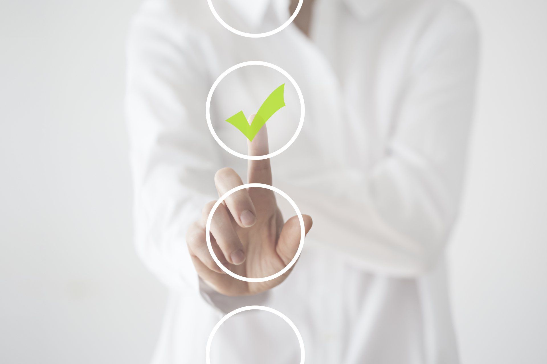 A person is pressing a button with a green check mark on it.