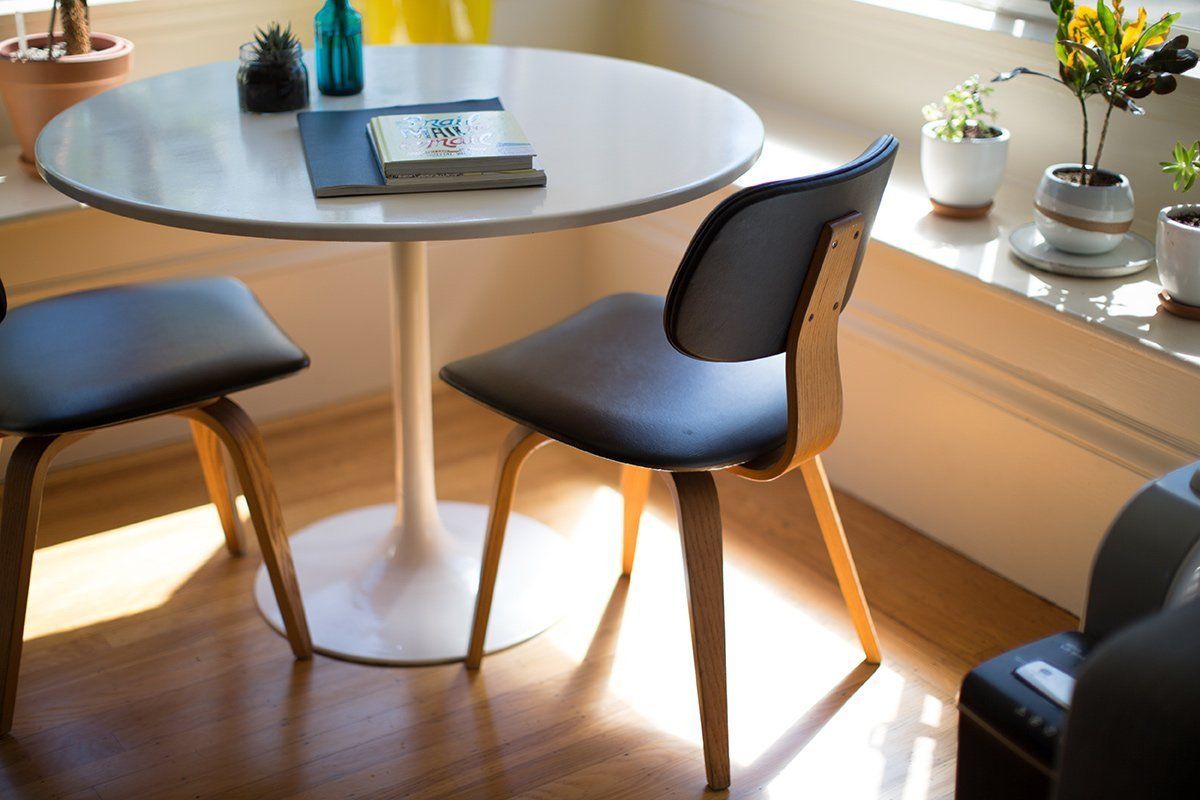 A round table with two chairs in a living room