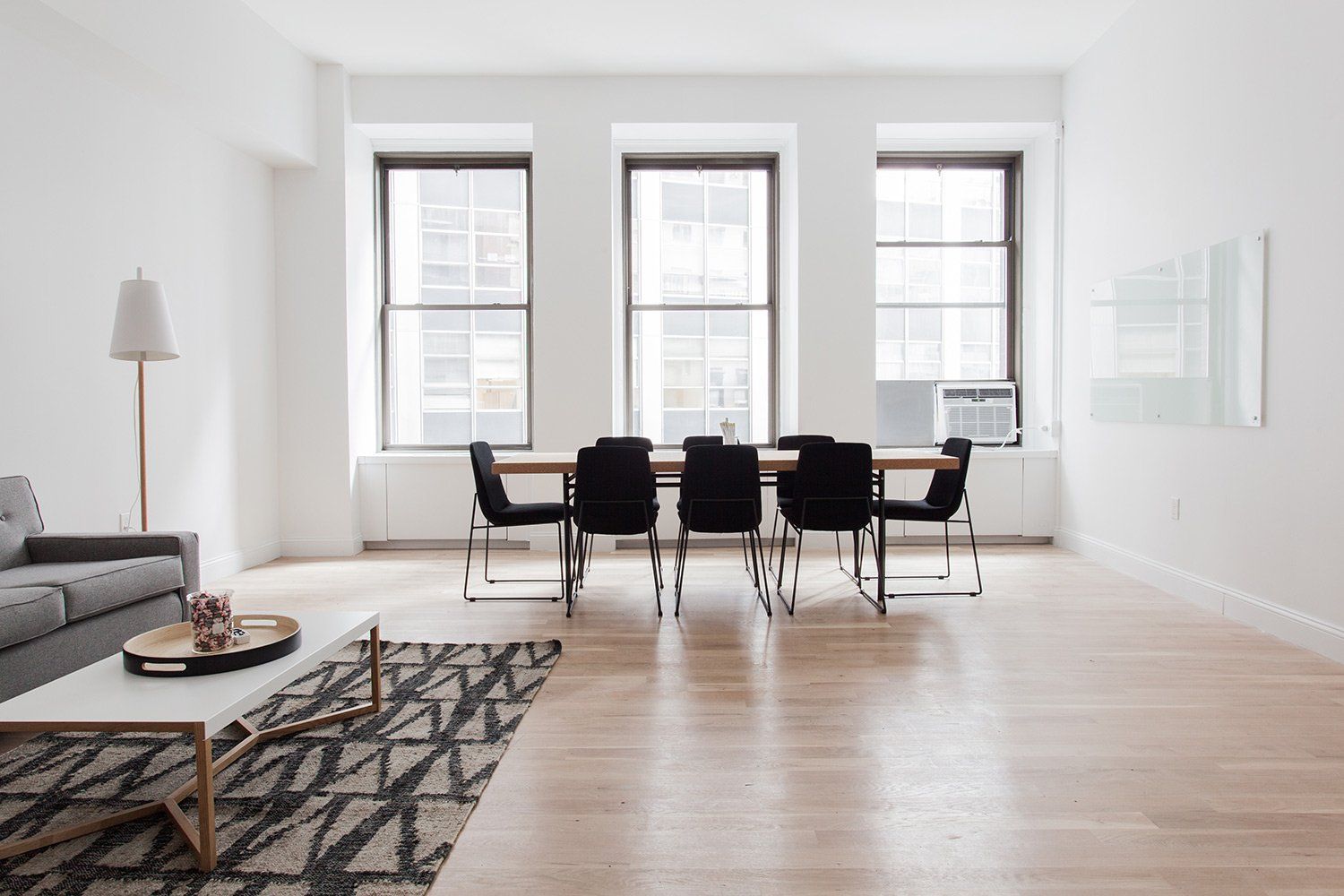A living room with a dining table and chairs and a couch.