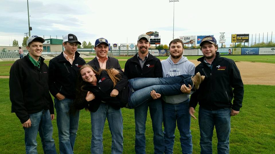 Brothers of Alpha Gamma Rho holding up a women