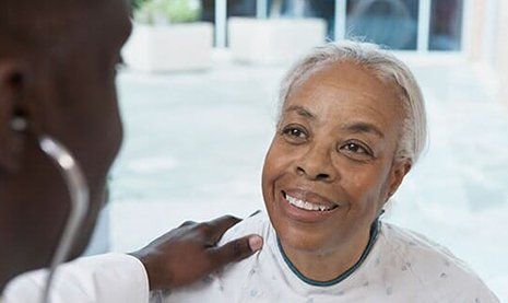 Patient Forms — Senior African Woman Smiling at African Doctor in Hospital in Dallas, TX Patient Forms — Senior African Woman Smiling at African Doctor in Hospital in Dallas, TX