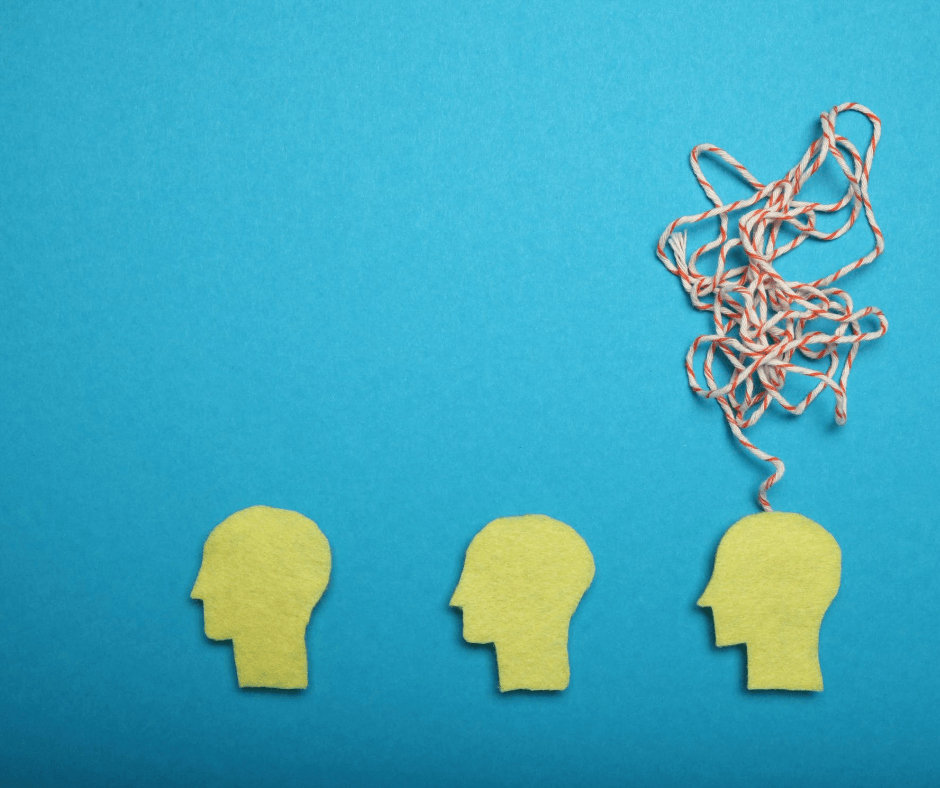 three paper heads figure with strings coming out of only one of them