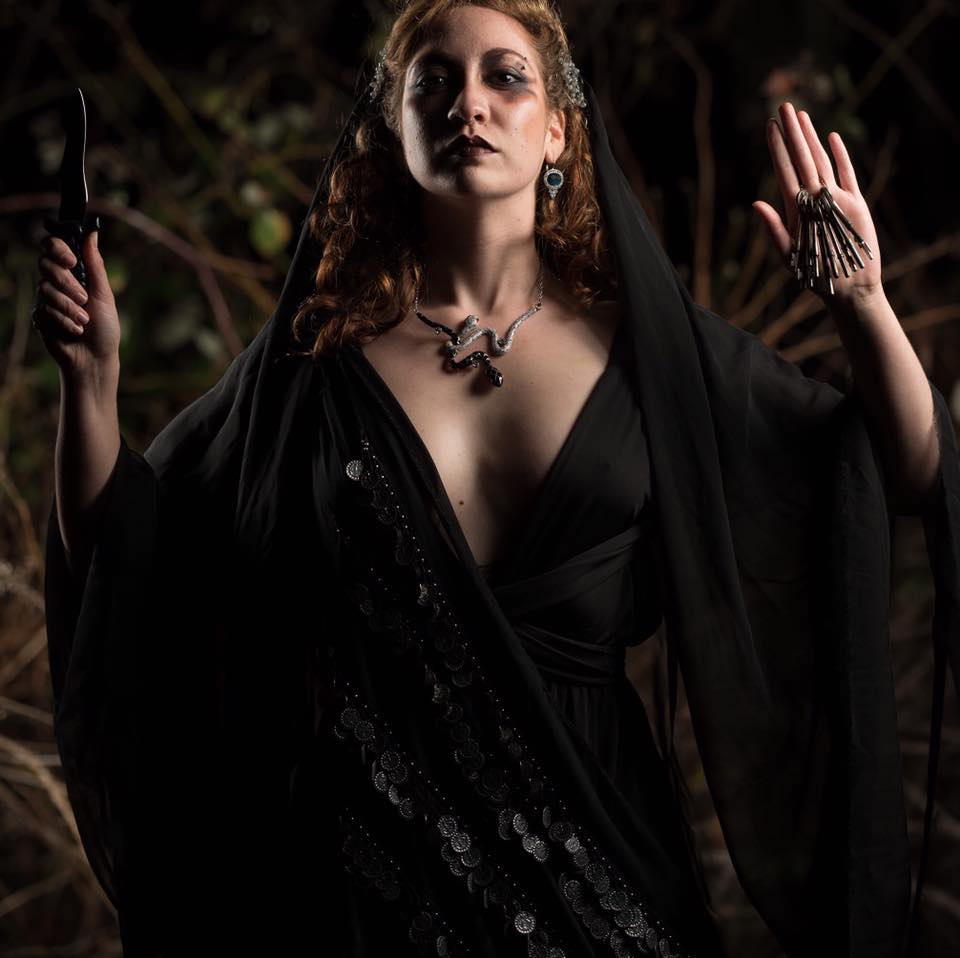 Woman in a black cloak for Hekates festival.