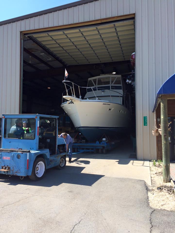 A boat is being towed out of a building