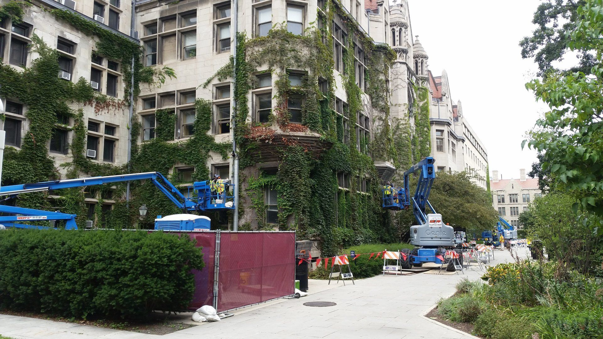 A large building with a lot of windows is being remodeled.