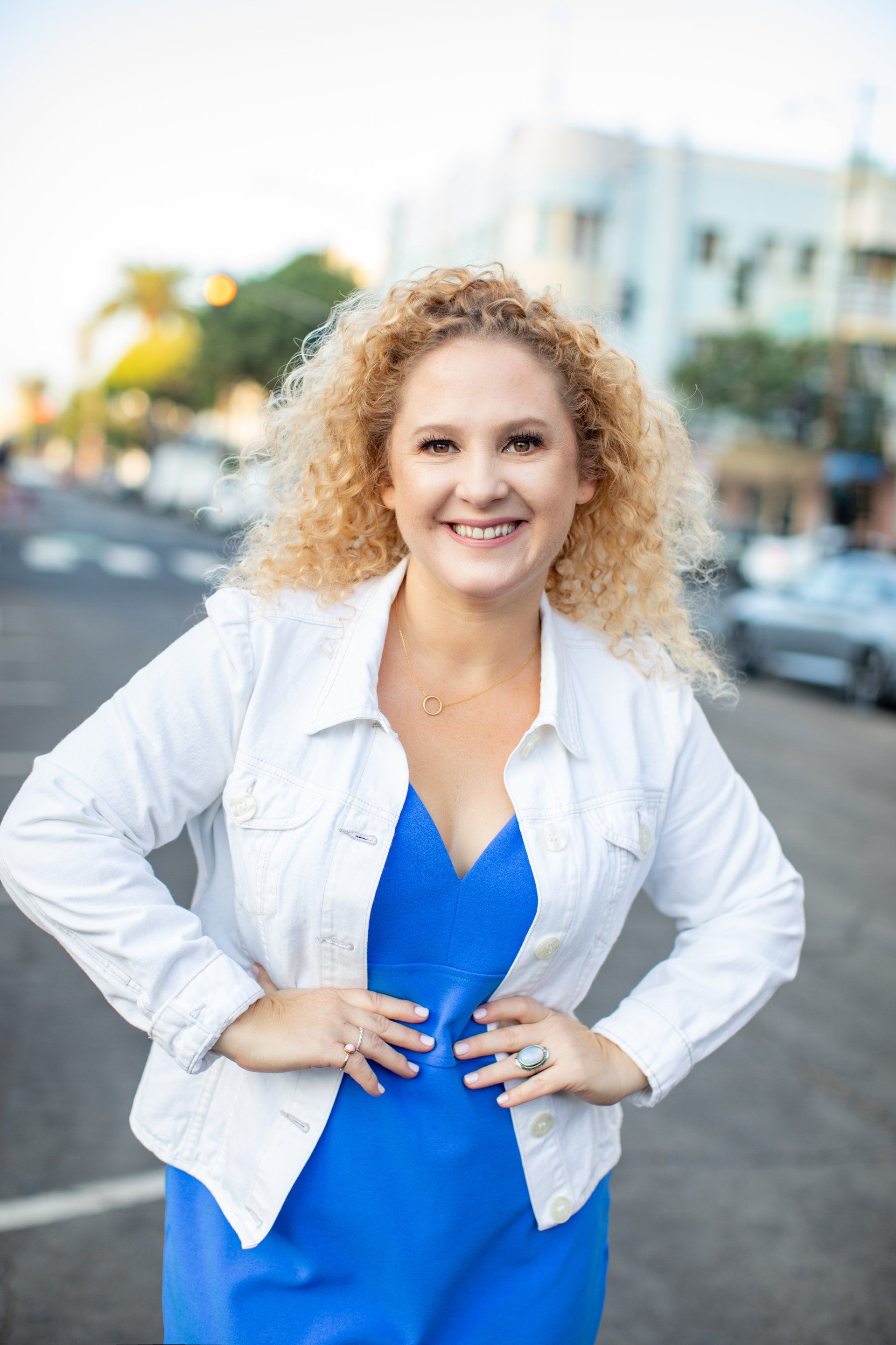 Personal branding portrait of a smiling entrepreneur on a city street in Orange County