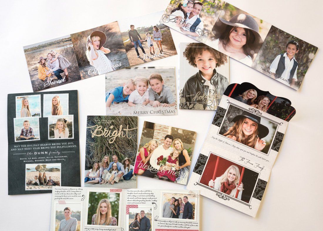 A bunch of pictures are sitting on top of each other on a table.