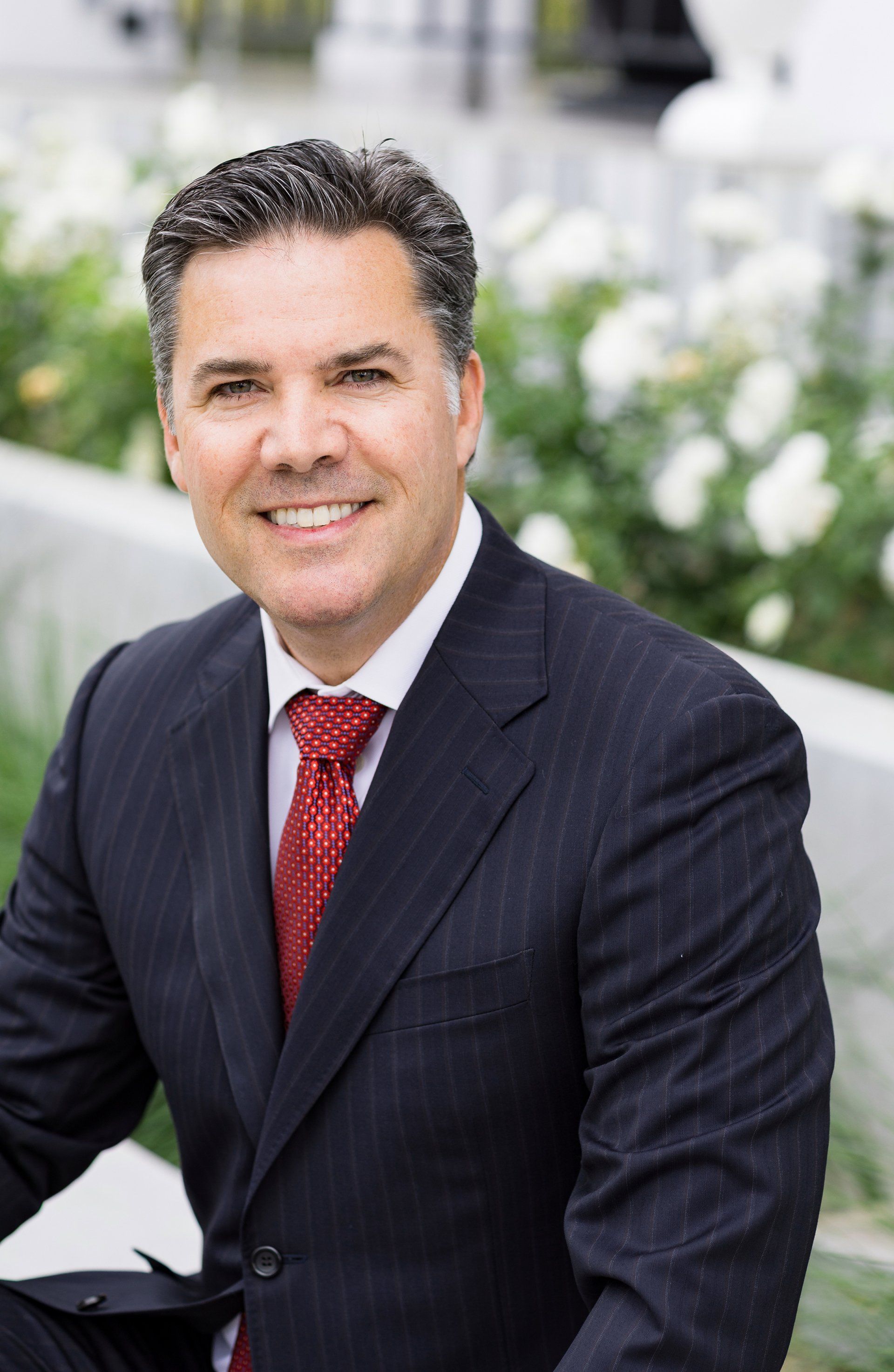 A man in a suit and tie is smiling for the camera.