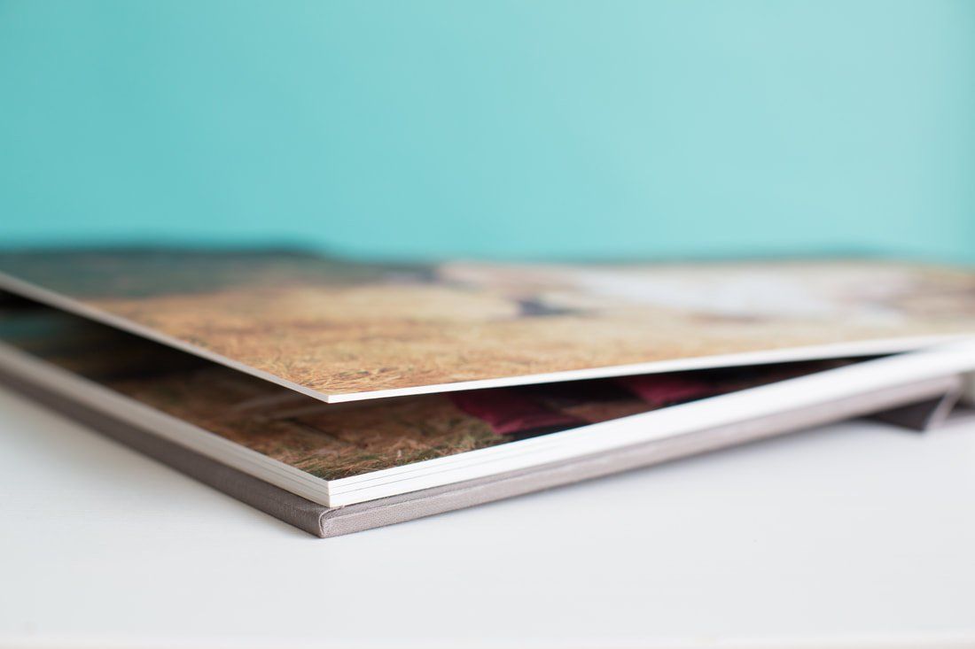 Two books are stacked on top of each other on a table.