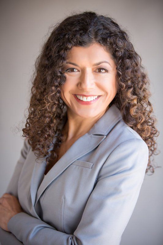 Professional business headshot of a woman in a suit
