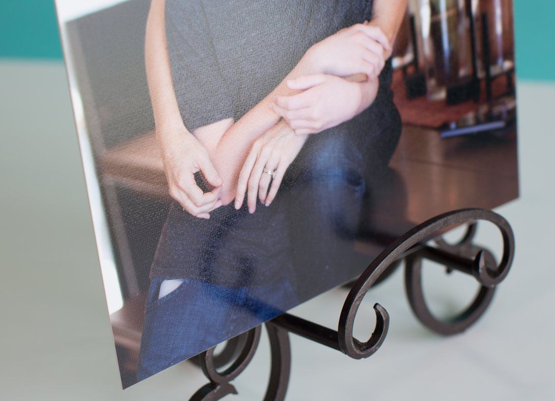 A picture of a woman sitting on a table on a metal stand