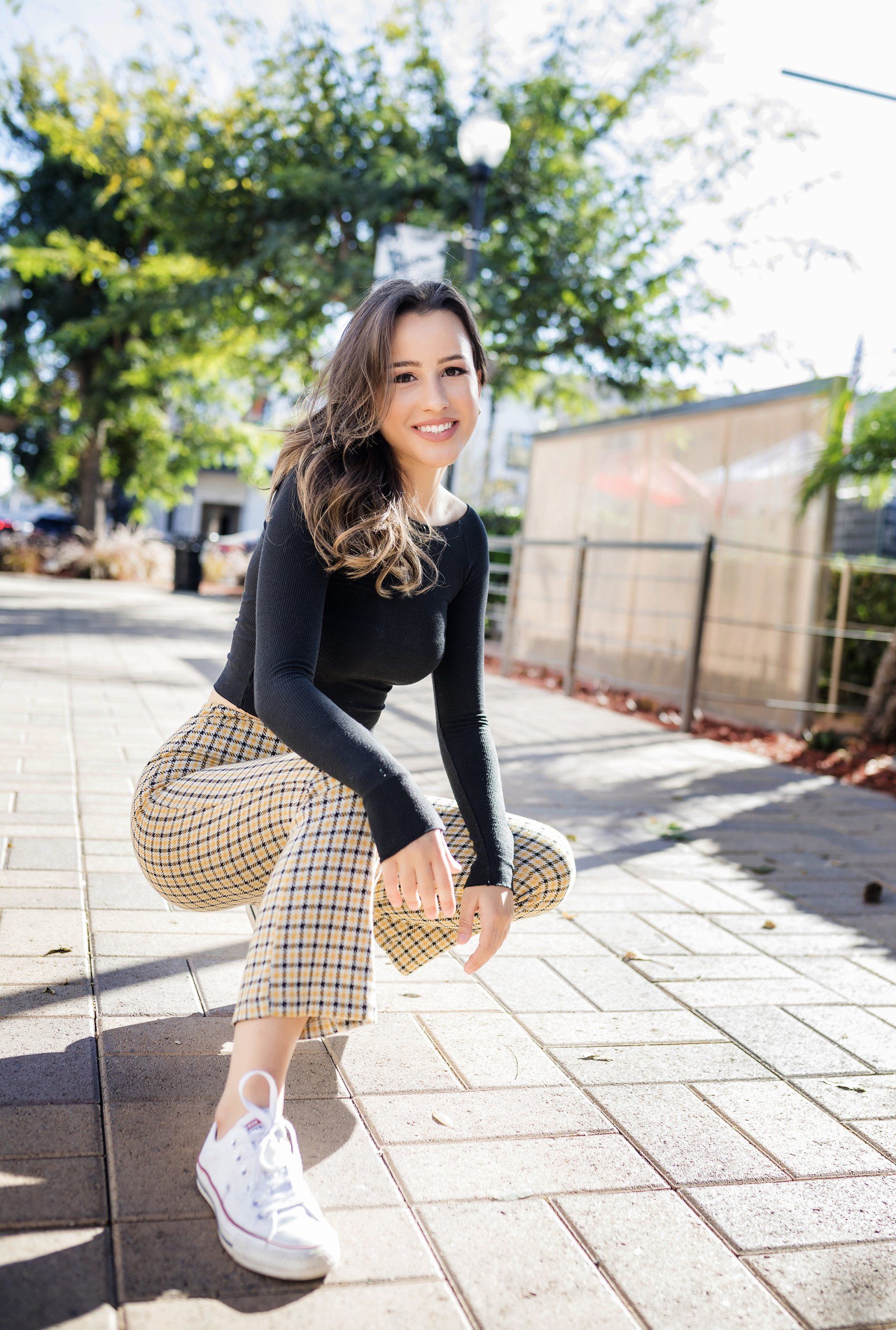 brunette hair is captured in a trendy outfit during her portrait session