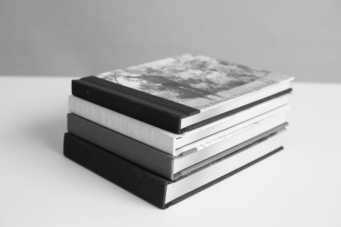 A stack of books sitting on top of each other on a table.