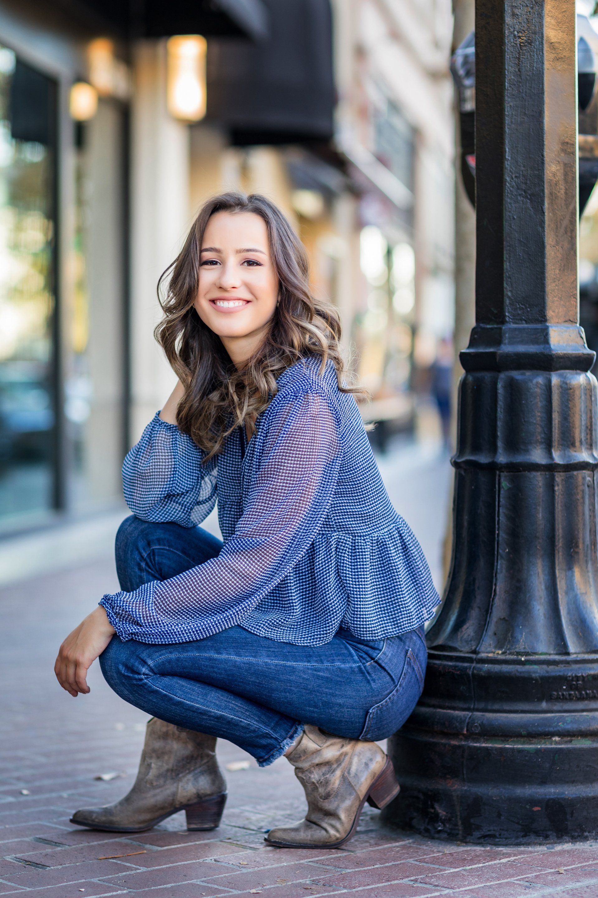 High School senior gal in the Santa Ana Art District posing for her senior portraits