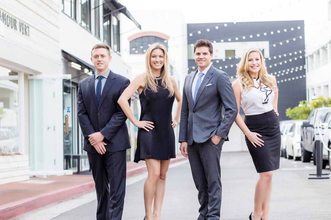 A group of people standing next to each other on a street.