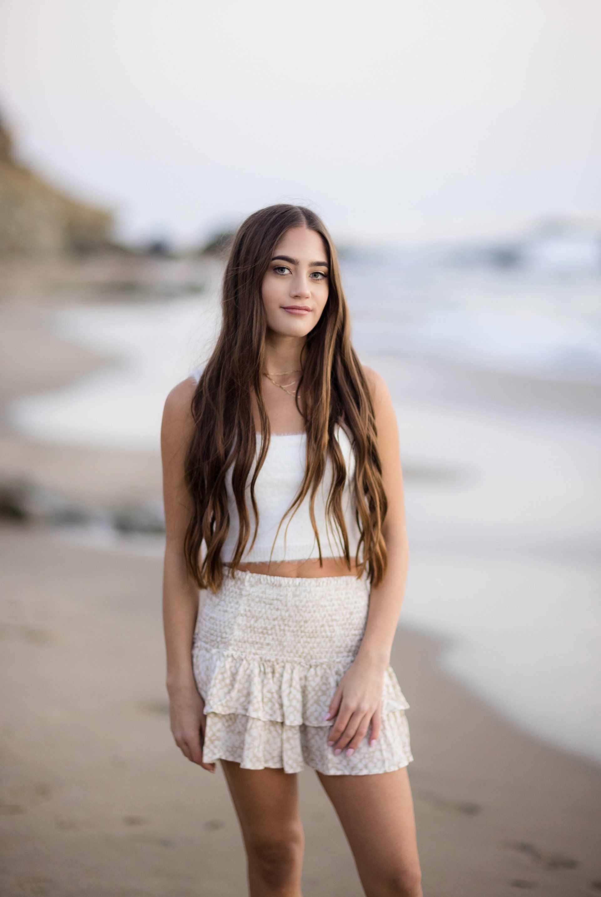 A portrait of elegance amidst the natural beauty of Orange County's coastline: a high school senior's moment in the sun