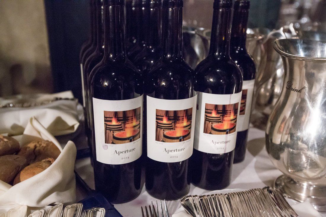 Several bottles of wine are lined up on a table