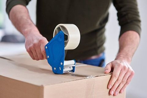 Packing Supplies — Man Taping Cardboard Box in Cheyenne, WY Packing Supplies — Man Taping Cardboard Box in Cheyenne, WY