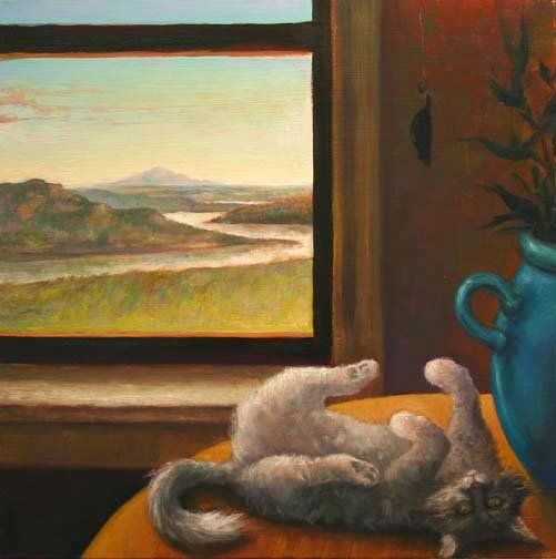 A cat is laying on its back on a table in front of a window.