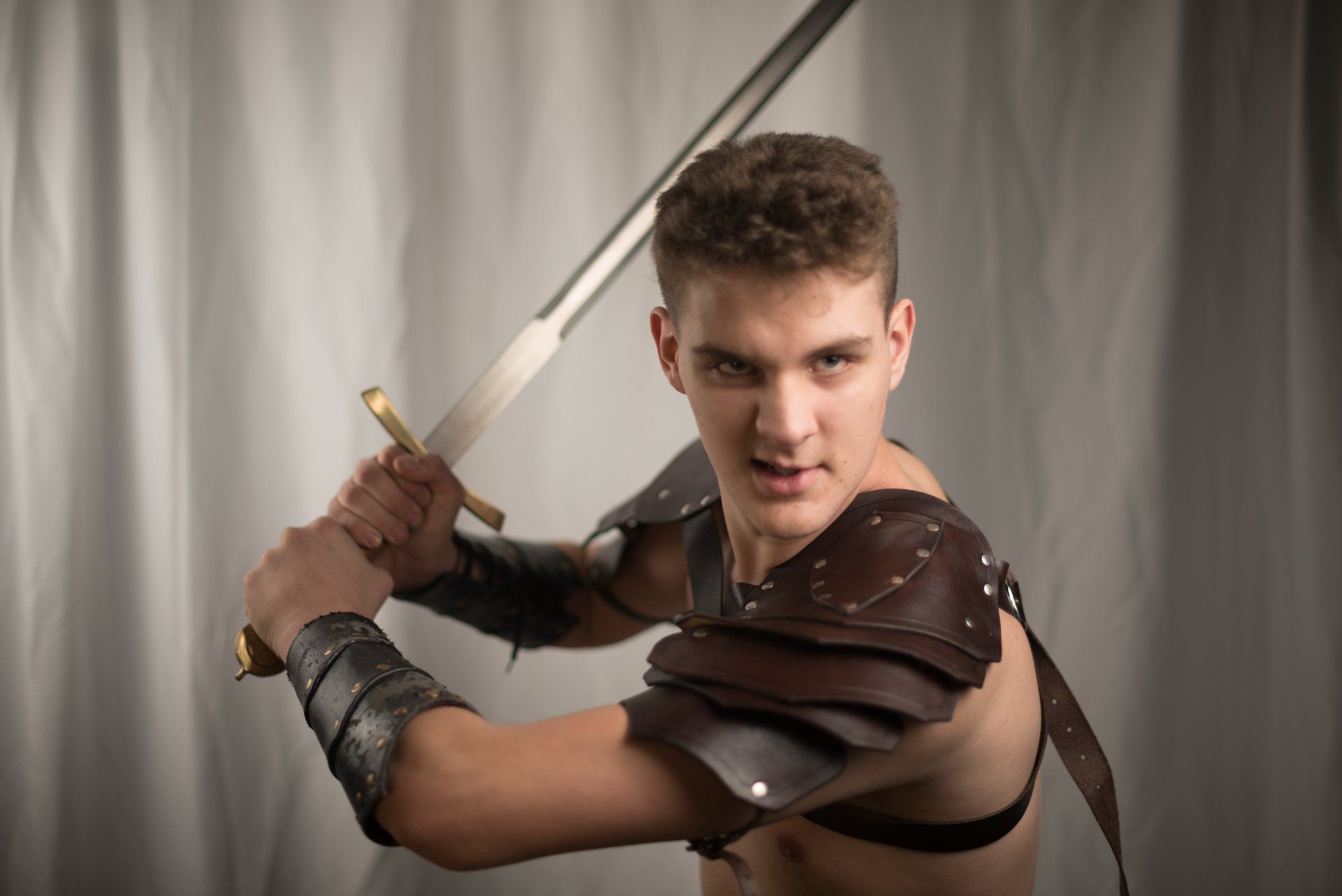 Man in armor holding a sword, representing Ares.