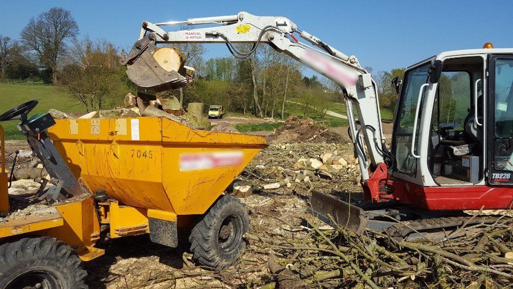 digger and dumper clearing ground