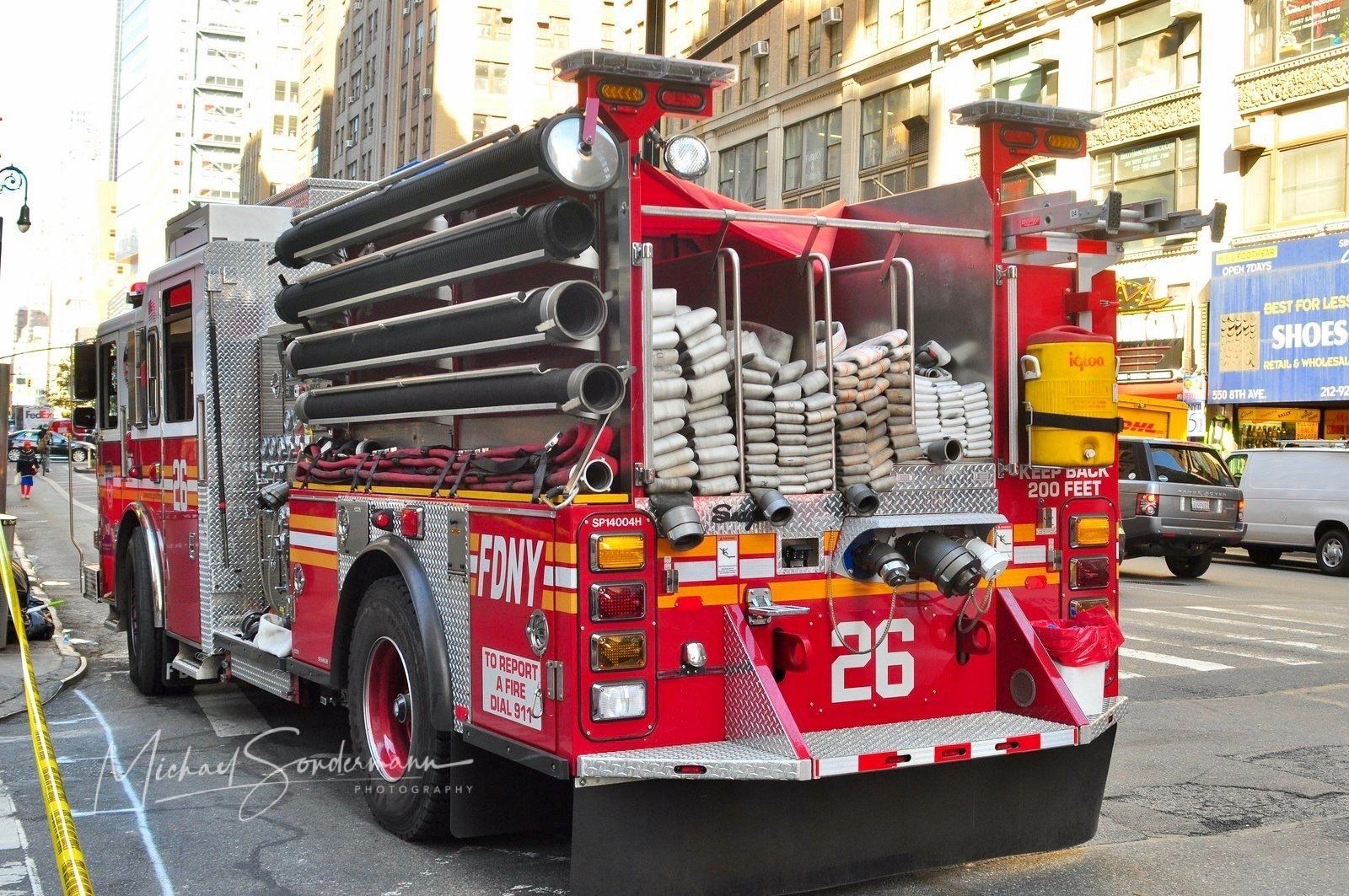 A red fire truck with the number 26 on the back