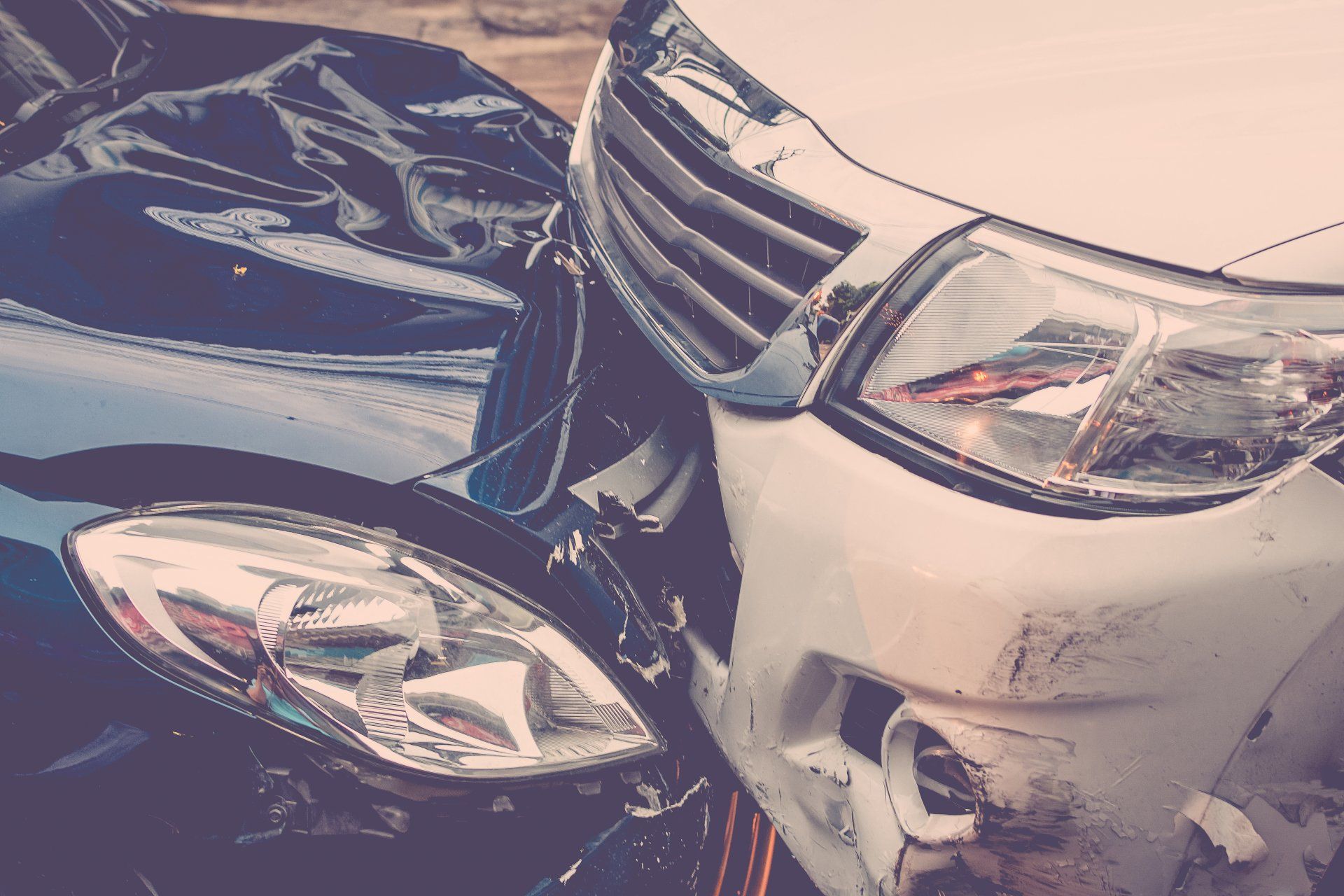 A black car and a white car are involved in a car accident.
