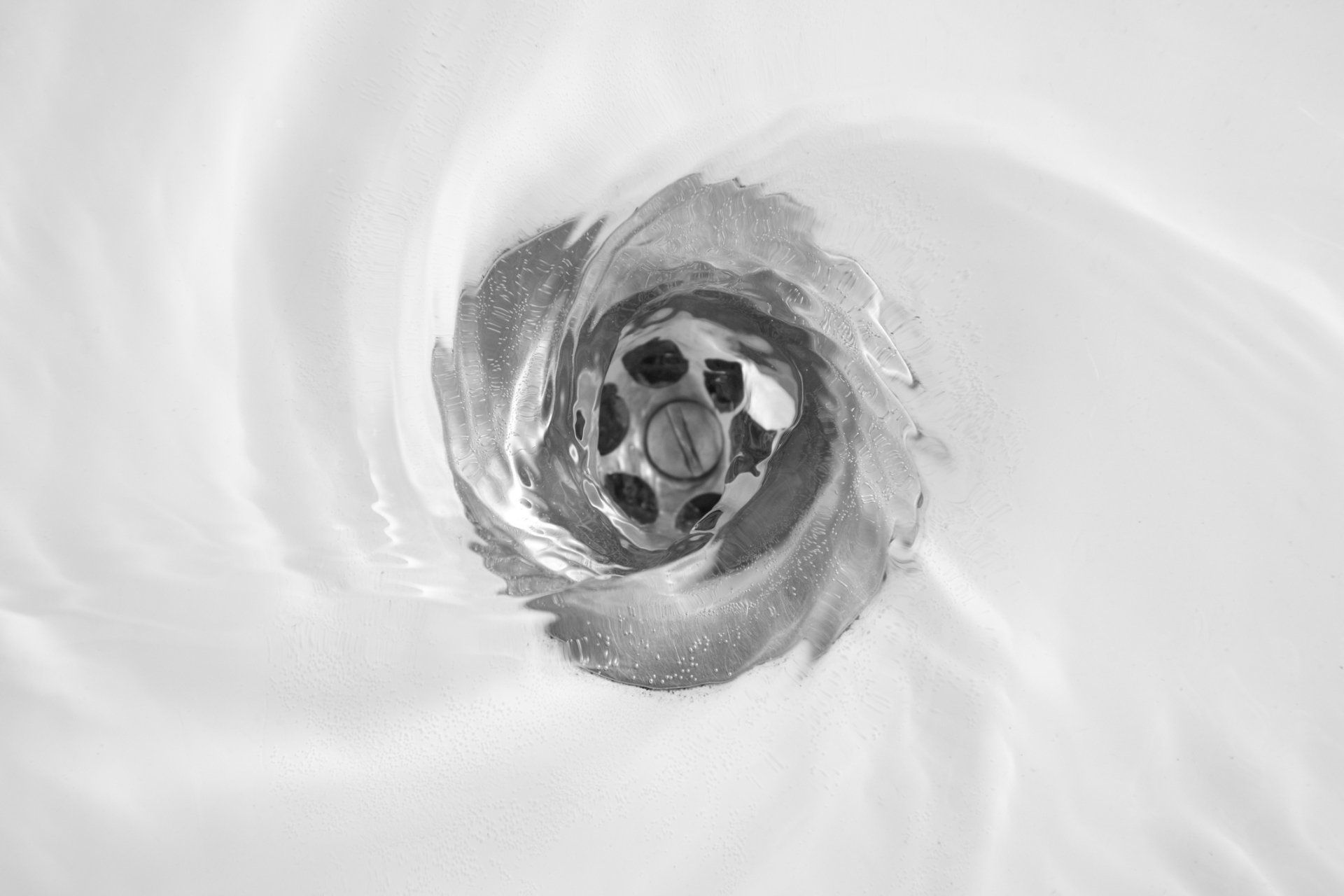 Plumber Fixing Sink Pipe — Middlebury, VT — Plouffe's Boiler & Mechanical Service Inc Plumber Fixing Sink Pipe — Middlebury, VT — Plouffe's Boiler & Mechanical Service Inc