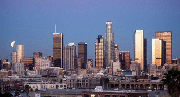 City skyline at sunset with modern high-rise buildings and a clear sky | Tony Wood Commercial Real Estate, Los Angeles