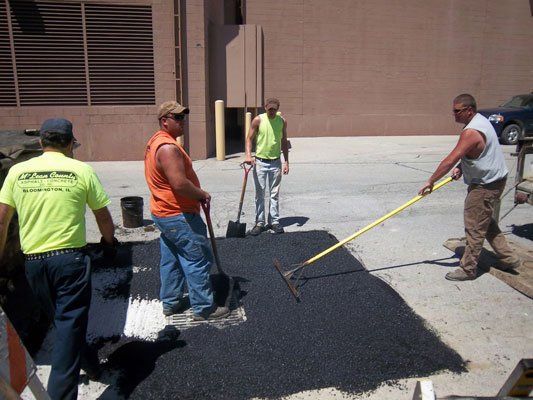 Workers Installing Hot Asphalt — Bloomington, IL — McLean County Asphalt Co.