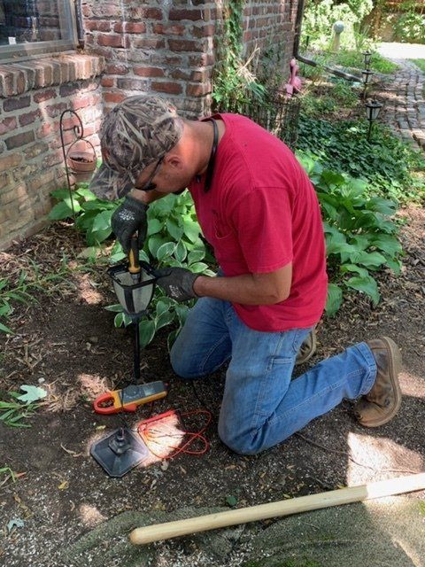 Electrician Fixing Electric Wall Socket — Peoria, IL — Oberlander Electric Electrician Fixing Electric Wall Socket — Peoria, IL — Oberlander Electric