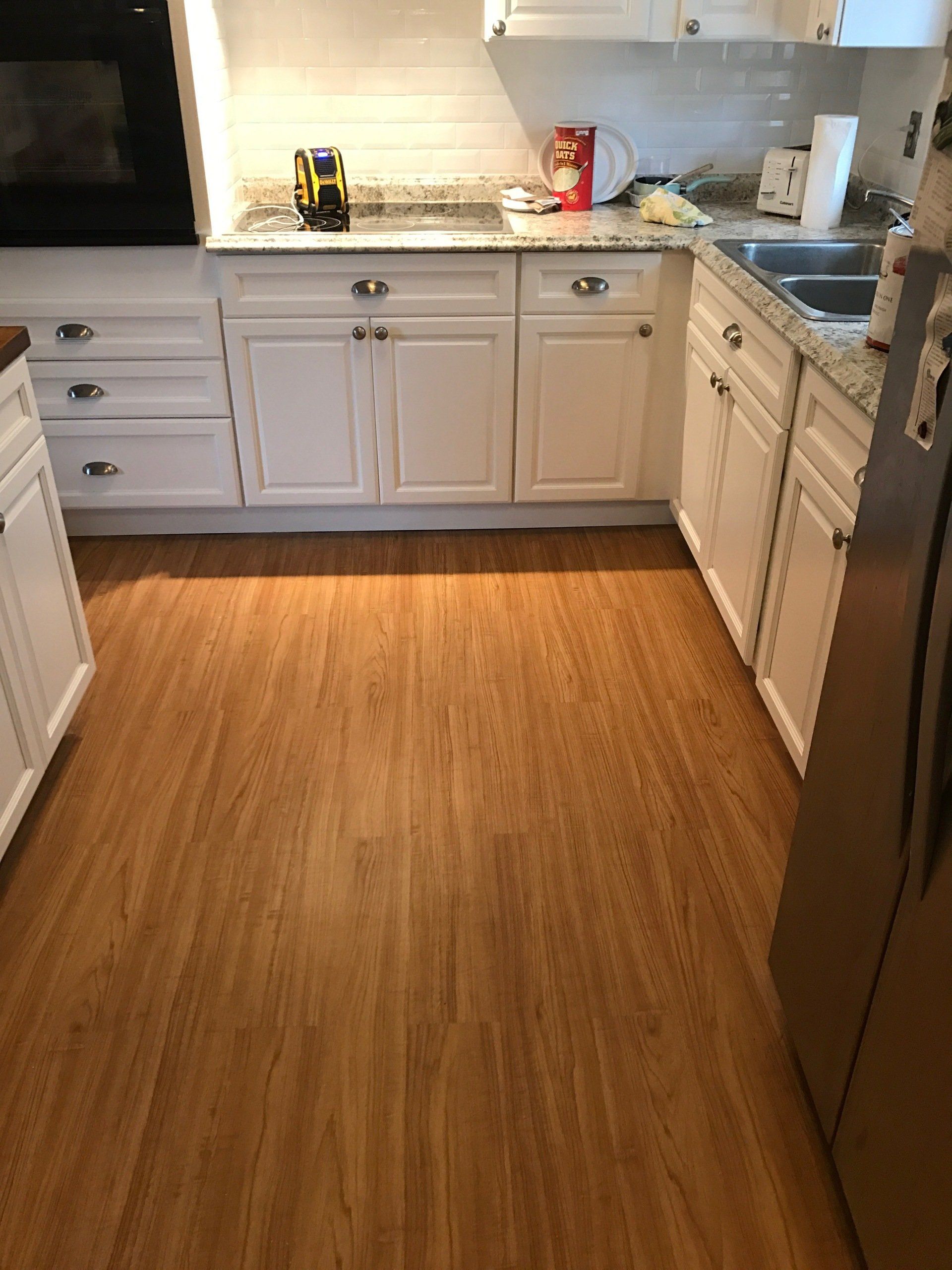 Stunning new cabinets, floor, and counters in kitchen designed by Al’s Home Remodeling LLC