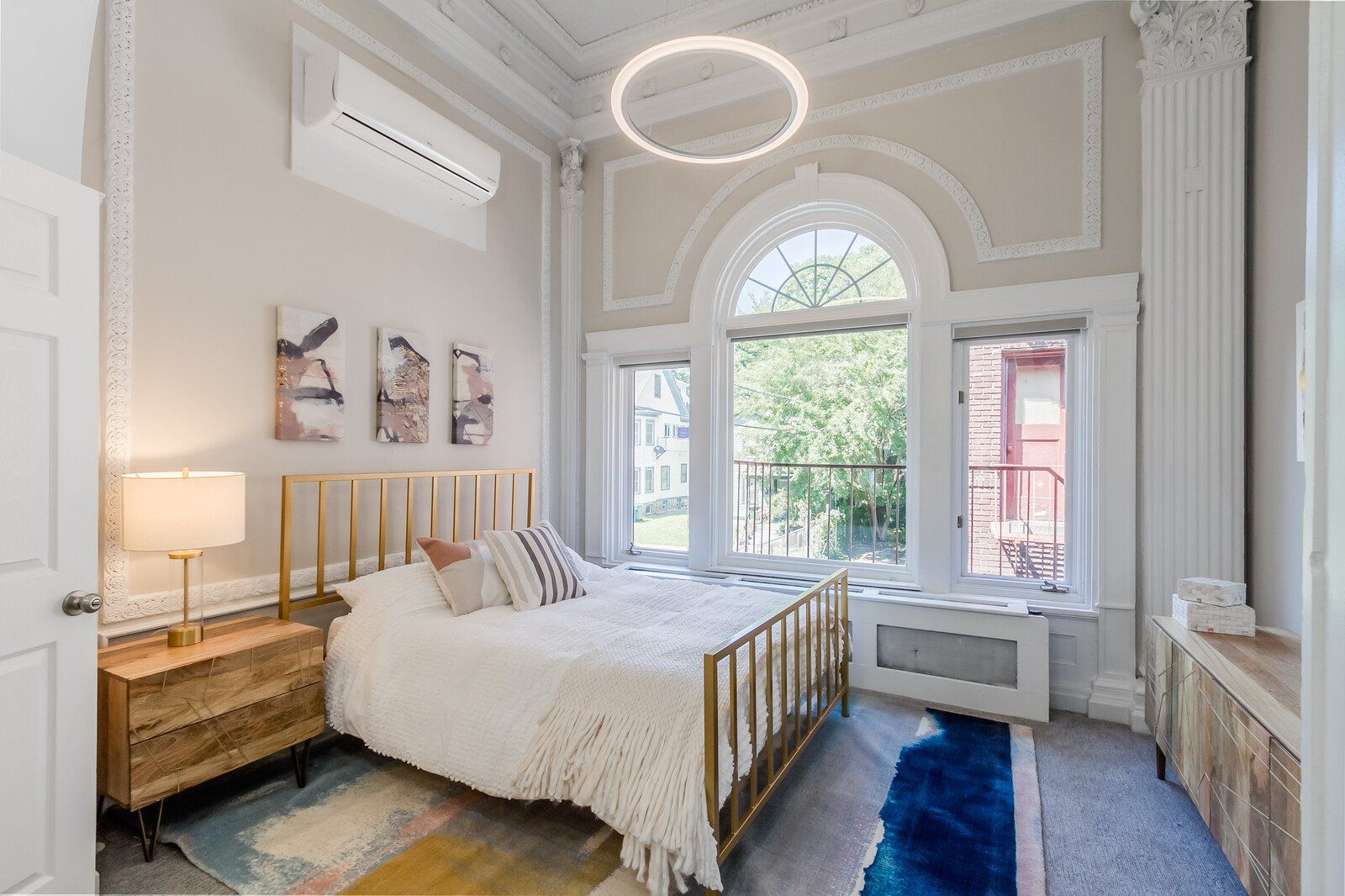 Ballroom bedroom with tall ceilings and bright natural lighting
