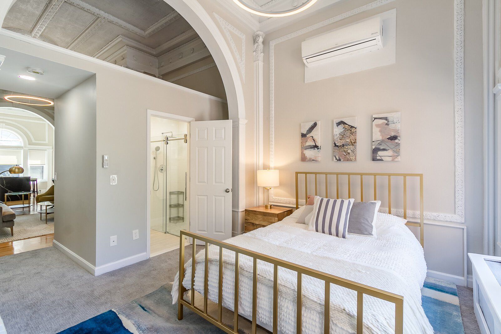 Ballroom bedroom with tall historic ceilings, and an en suite bathroom