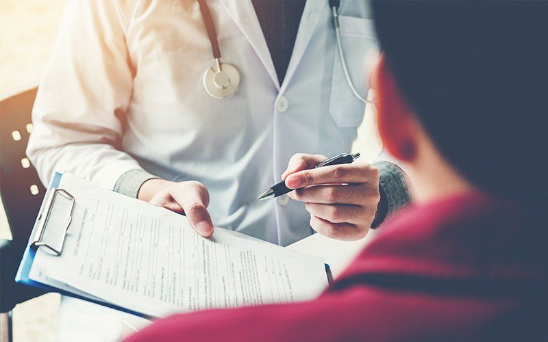 Doctor Showing Patient Form — Lafayette, LA — Acadiana Urgent Care Center