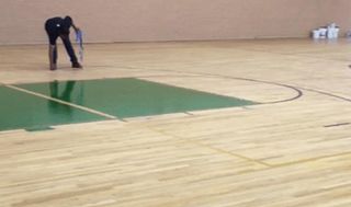 Gymnasium Floor Being Polished — Los Angeles, CA — K & Z Hardwood Flooring Gymnasium Floor Being Polished — Los Angeles, CA — K & Z Hardwood Flooring